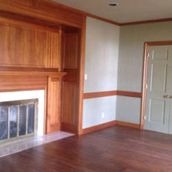 Fireplace with stained surround and wood floors